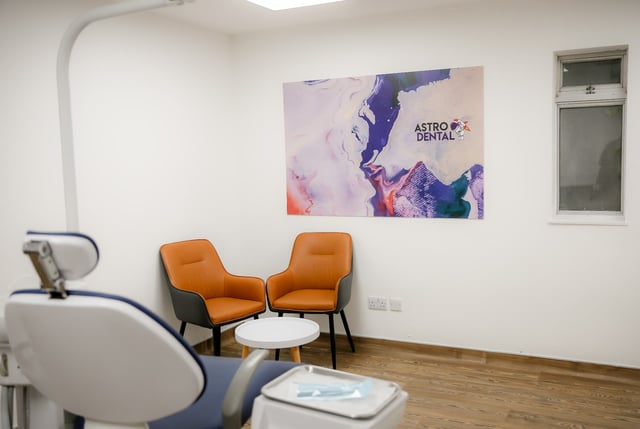 A clinician reviewing a dental scan in a bright surgery at Astro Dental